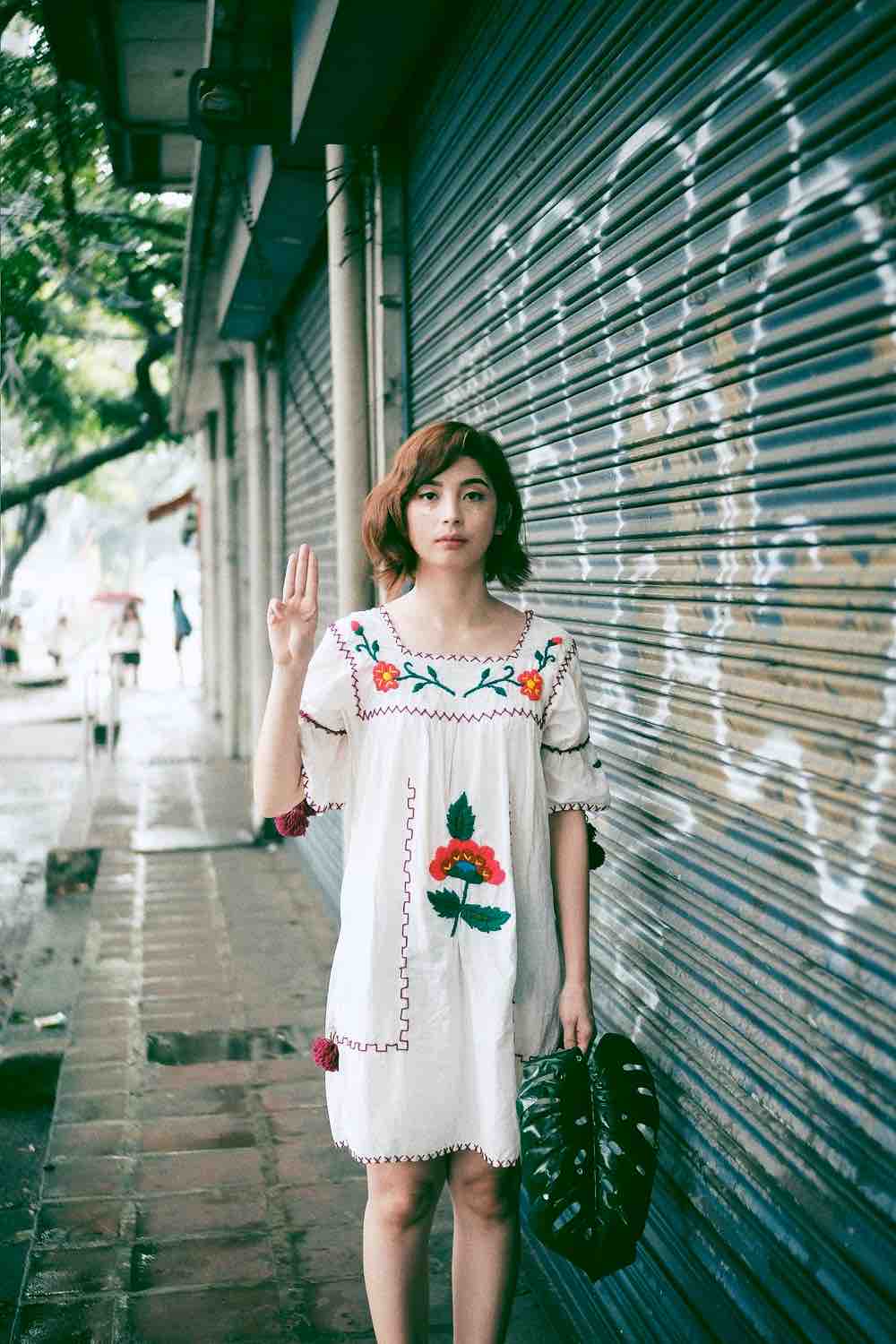 Woman Standing Near Roller Shutter | Cute Spring Dresses That Will Make You Stand Out