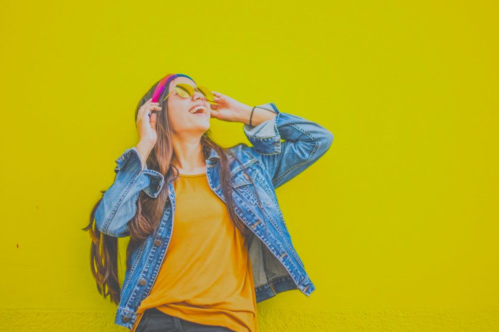 Smiling Woman Standing Against Yellow Wall | Cute Outfits for Teens Great for Everyday Look