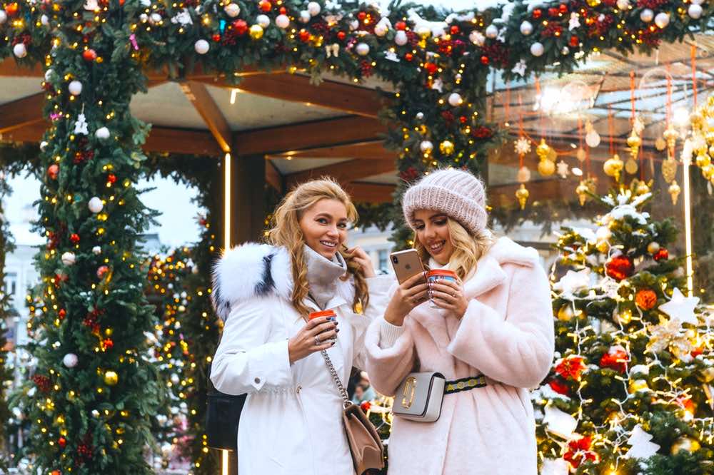 Two Women Near Christmas Decorations | Winter Coat Guide | 9 Ideas To Finding The Right One For You