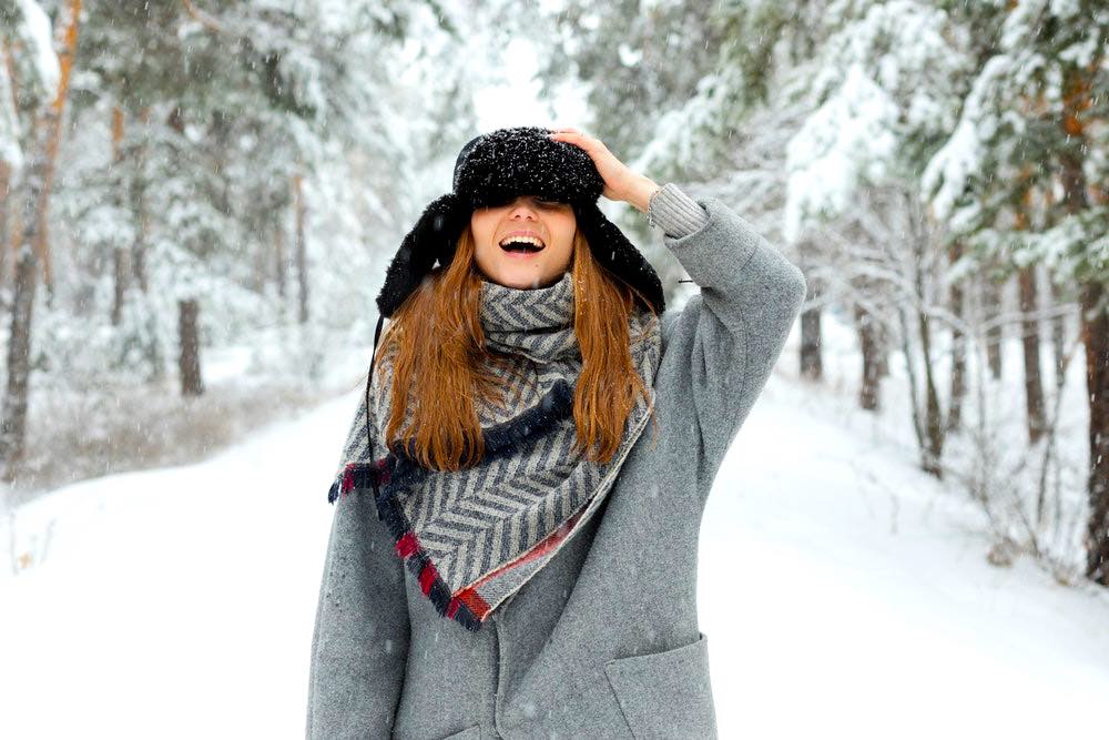 Woman In Grey Coat Holds Cap | Winter Coat Guide | 9 Ideas To Finding The Right One For You