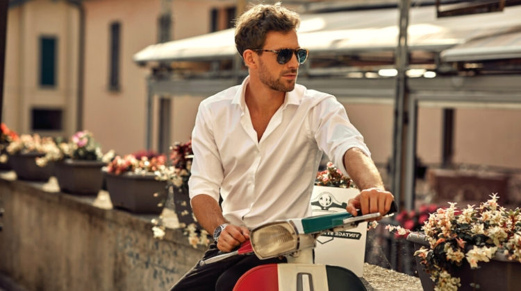 Stylish italian man wearing white shirt and sitting on classic scooter | Cute Summer Outfits For Men | Street Style Looks | Featured