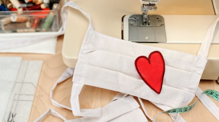 Homemade facemask against virus infection in detail with sewing machine and heart emblem | Top Fashion Companies Who United To Fight Covid-19 | beauty companies | Featured