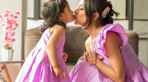 A lovely moment of a beautiful mother and daughter in matching dress | Cute Mommy And Me Outfits For A Matchy-Matchy Mother's Day | mommy and me matching clothes | Featured