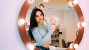 young beautiful woman taking selfie in front of vanity mirror |Hollywood Stars Trending Instagram Outfits During Lockdown | instagram outfits | Featured