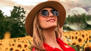 Woman Surrounded by Sunflowers Raising Hand | Best Polarized Sunglasses Worth Online Shopping | best polarized sunglasses for women | Featured