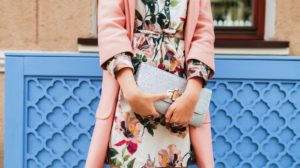 Young beautiful stylish woman walking in street in pink coat, floral printed dress, holding silver purse in hands | Trendy Spring Purses and Bags To Match Your Cute Outfit | new bag | Featured