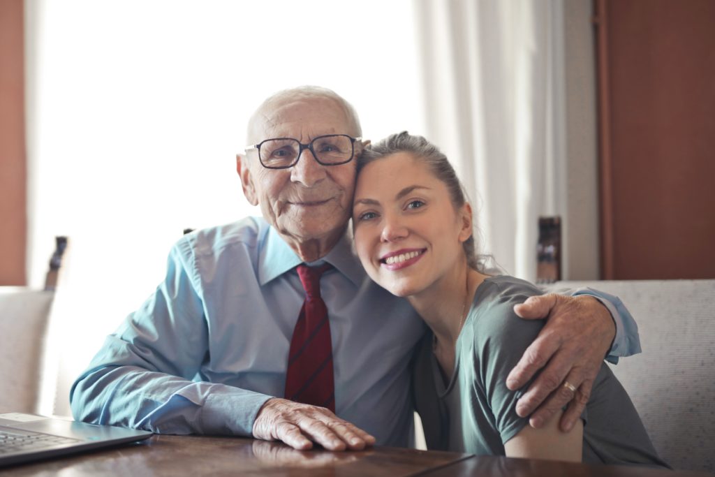 Positive senior man in formal wear and eyeglasses hugging | Budget-Friendly Gifts For A Dad Who Wants Nothing | gifts for dad | Featured