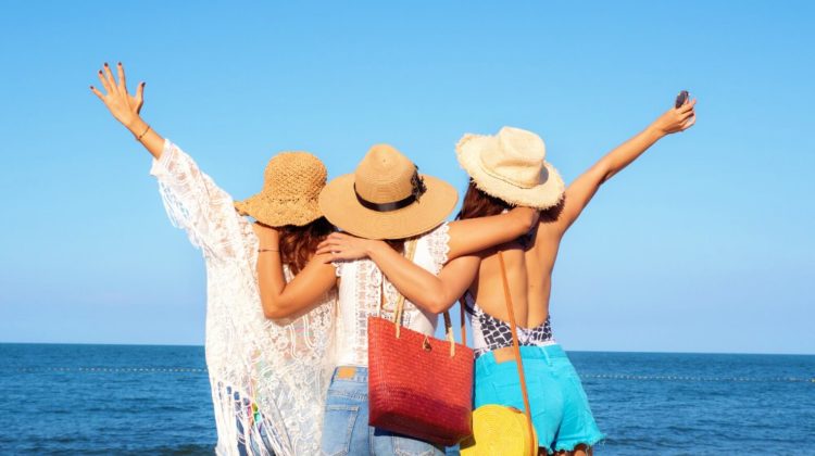 Back of women wearing hat enjoying on the beach, lifestyle concept | Strut Under The Hot Sun With These Cool Sun Hats For Women | stylish sun hats | Featured