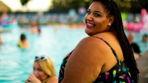 Smiling woman beside pool | Hottest Plus Size Tankini Swimsuits You Need To Have This Summer | plus size bikinis | Featured