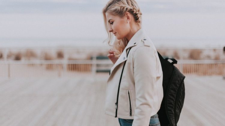 woman in black zip up jacket with black backpack | Lightweight Jackets Perfect For Cool Summer Nights | lightweight jacket | Featured