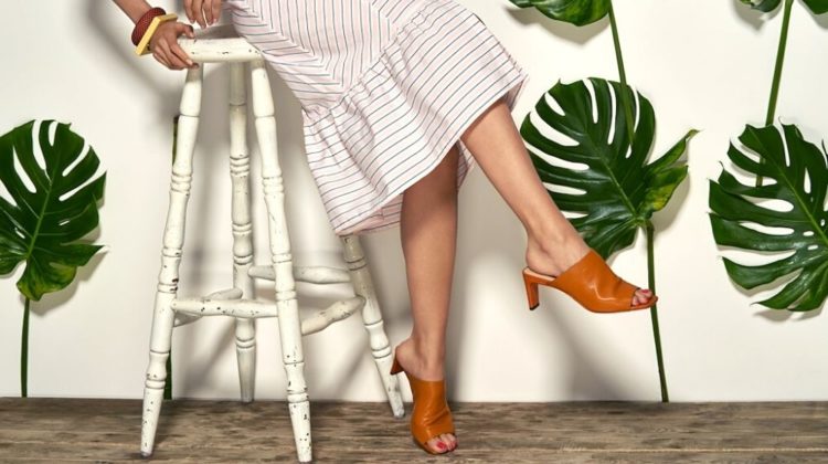 She wears a striped pink dress, bracelets and brown mule shoes | Classy Heeled Mules You Need To Add To Your Wardrobe | Featured