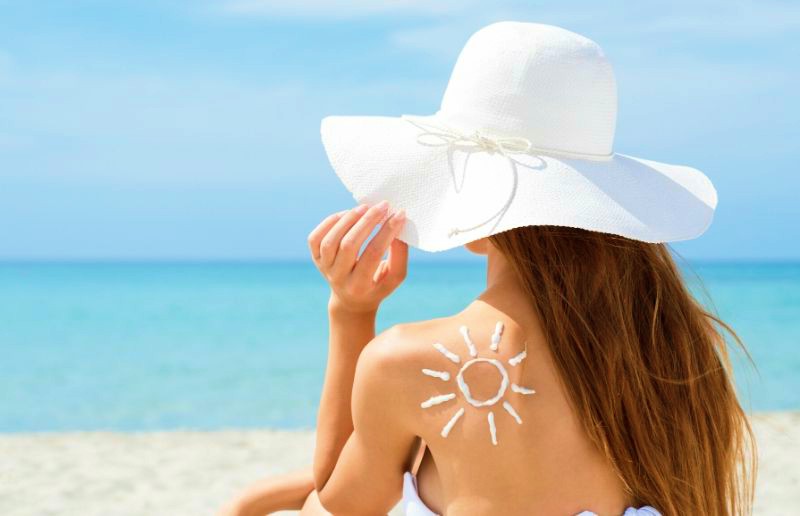 Rear View Of A Young Woman In Bikini And Sun Drawn On Back With Sun Protection Cream | Benefits Of Sunscreen Spray You Should Know Before Heading Out | sun protection