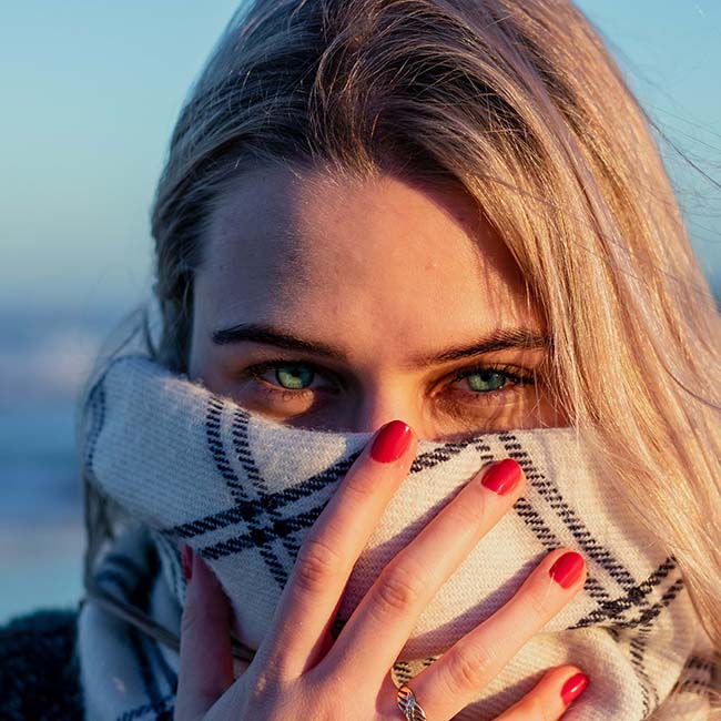 close up photo of a woman covering her face with scarf | Types of Scarves Every Stylish Woman Should Know