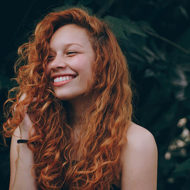 smiling woman with red hair | Fall Hair Colors You Should Try Next