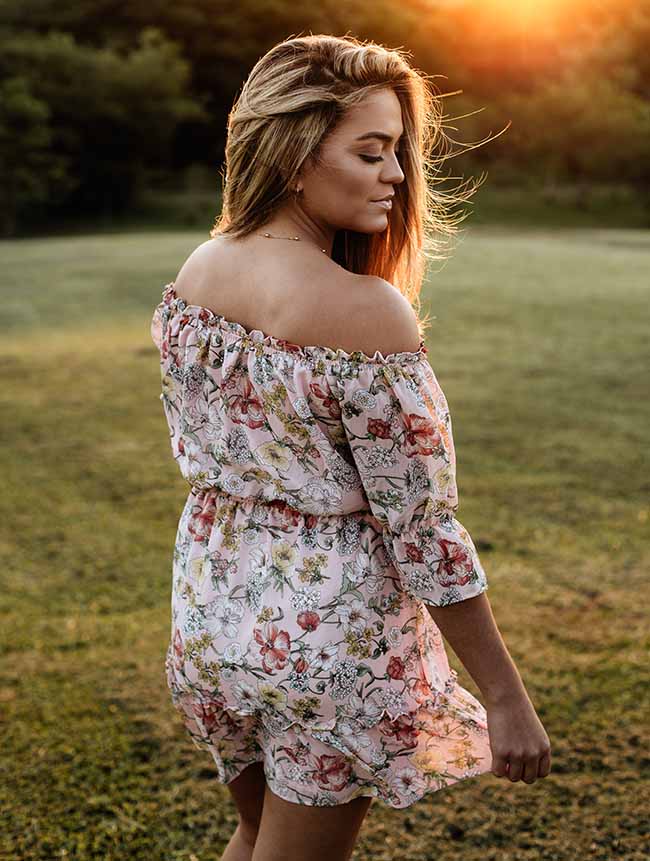 woman wearing pink and white floral off shoulder playsuit | Playsuits To Wear When It's Too Warm For Jumpsuits | romper