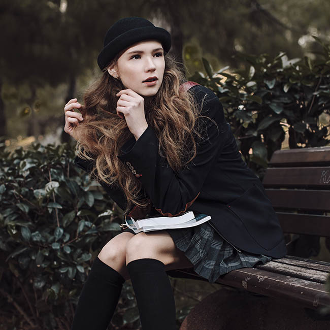 young student sitting on bench | Ways To Pull Off Fall Hats This Season